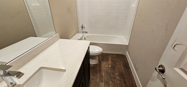 full bathroom with vanity, tiled shower / bath combo, and toilet