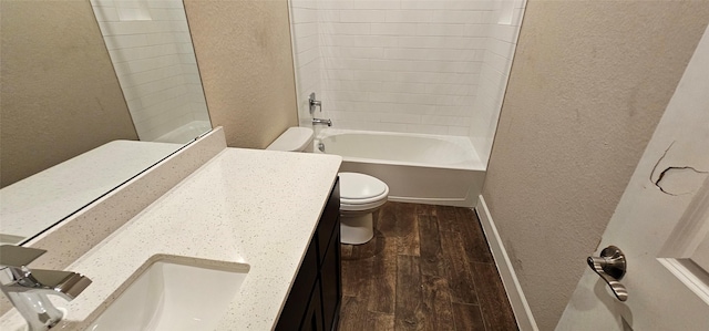 full bathroom featuring tiled shower / bath, wood-type flooring, toilet, and vanity