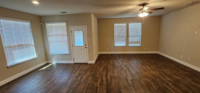 kitchen with sink, a center island with sink, dark hardwood / wood-style floors, and appliances with stainless steel finishes