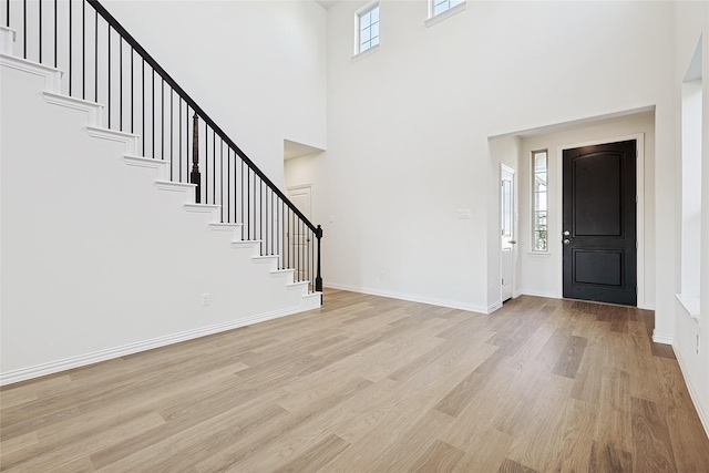 3913 Sky Dr, Sherman, TX 75090 - foyer entrance featuring stairs, light wood finished floors, a towering ceiling, and baseboards