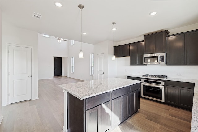 3913 Sky Dr, Sherman, TX 75090 - kitchen with stainless steel appliances, light wood-style flooring, ceiling fan, dark brown cabinets, and recessed lighting