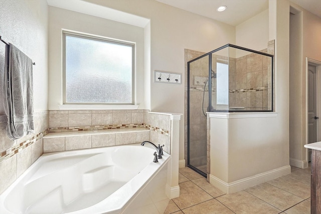 bathroom featuring tile patterned flooring, a healthy amount of sunlight, and separate shower and tub