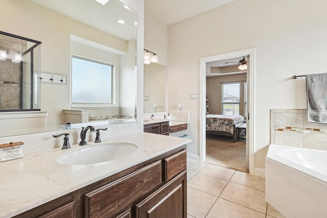 bathroom with ceiling fan, separate shower and tub, vanity, and tile patterned floors