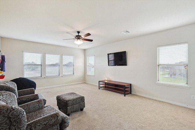 living area with carpet, ceiling fan, and a wealth of natural light