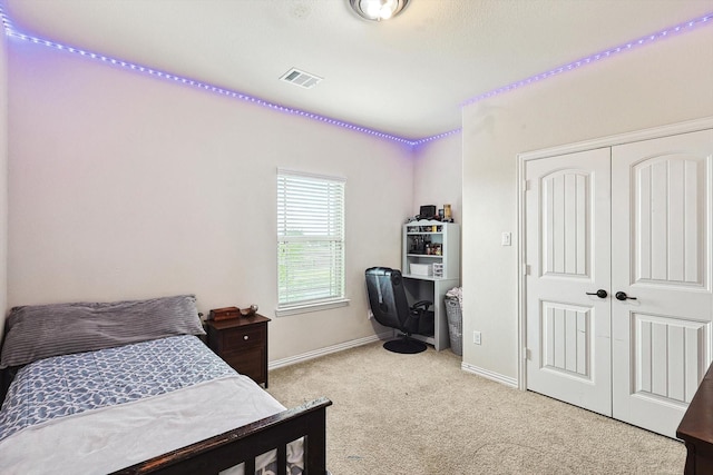 bedroom with a closet and light colored carpet