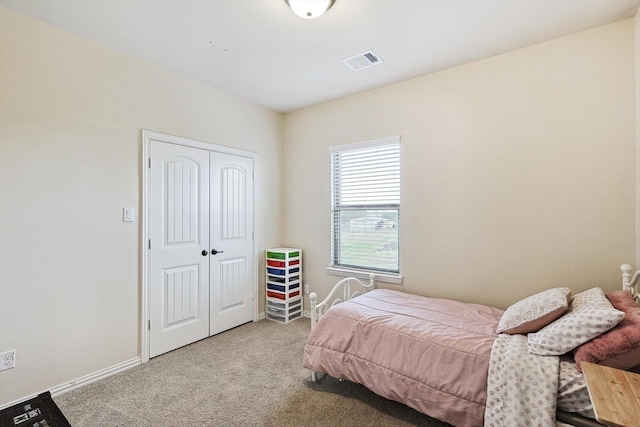 carpeted bedroom featuring a closet