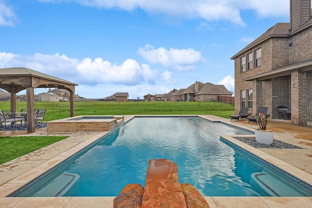 view of pool with a gazebo, a patio, a yard, and an in ground hot tub