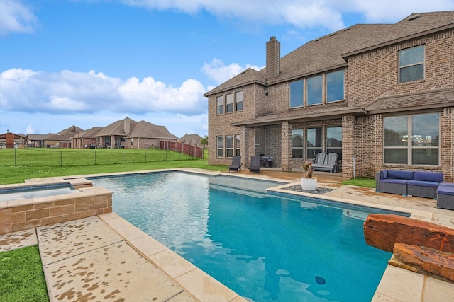 view of pool featuring a yard, an in ground hot tub, a patio area, and outdoor lounge area