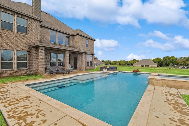 view of swimming pool with a patio area and a jacuzzi