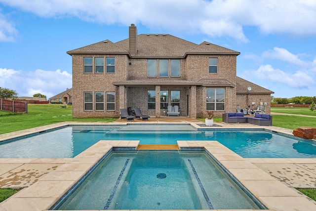 back of house with a patio area, a yard, a swimming pool with hot tub, and an outdoor living space