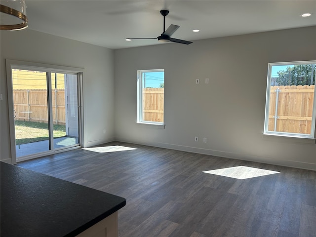 empty room featuring ceiling fan and dark hardwood / wood-style flooring