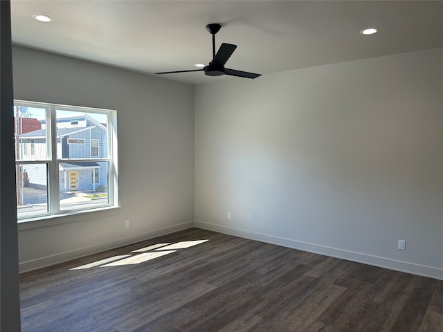 spare room with ceiling fan and dark hardwood / wood-style flooring