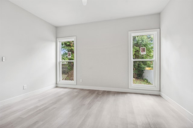 spare room featuring light hardwood / wood-style flooring and a wealth of natural light