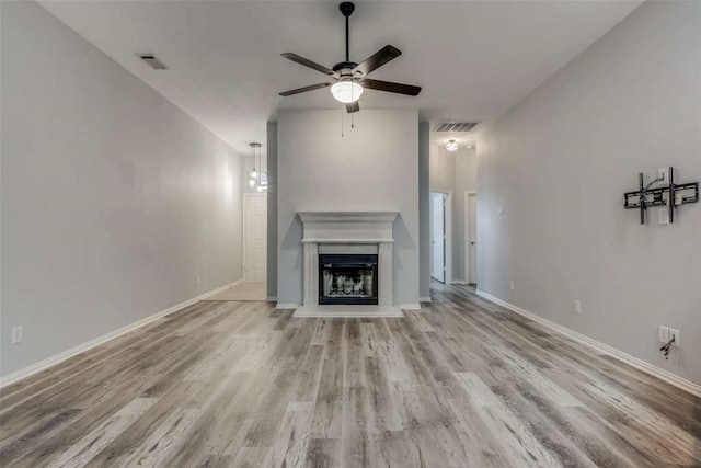 unfurnished living room featuring ceiling fan and light hardwood / wood-style floors