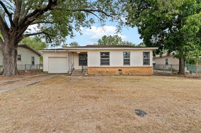 ranch-style home featuring a garage and a front yard