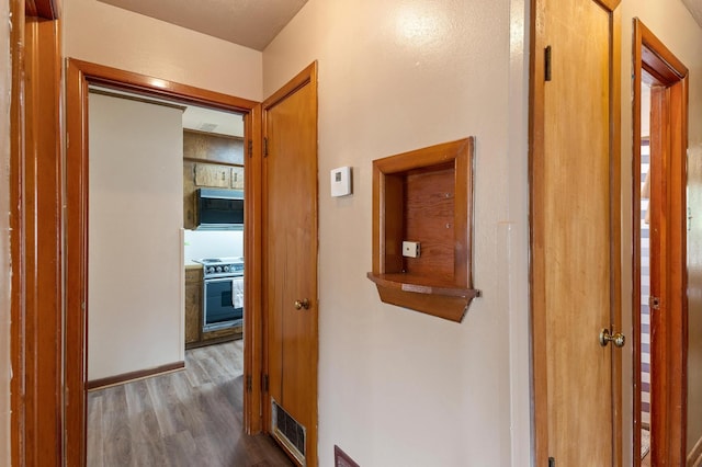 corridor featuring dark hardwood / wood-style floors