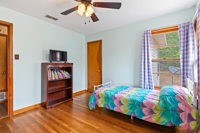 bedroom with ceiling fan and hardwood / wood-style flooring