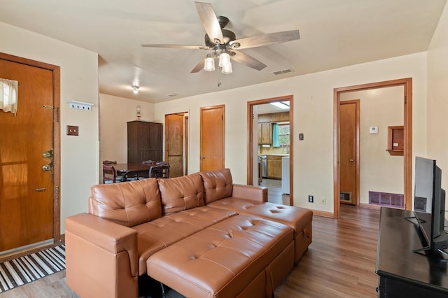 living room featuring ceiling fan and hardwood / wood-style flooring