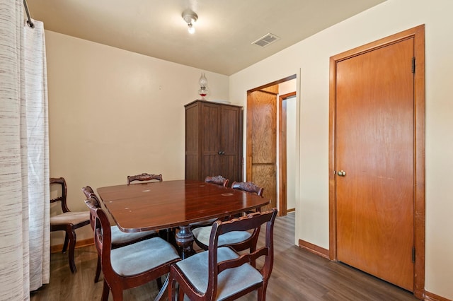 dining area featuring dark hardwood / wood-style floors