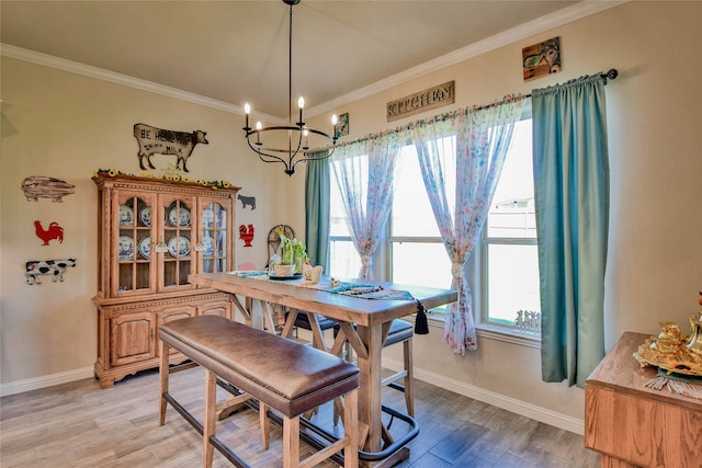 dining space featuring a notable chandelier, light hardwood / wood-style floors, ornamental molding, and a wealth of natural light