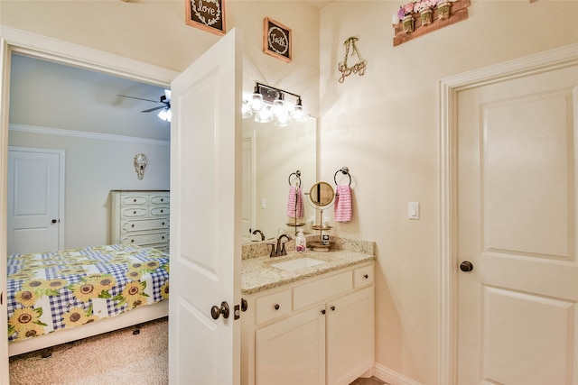 bathroom with ornamental molding, vanity, and ceiling fan