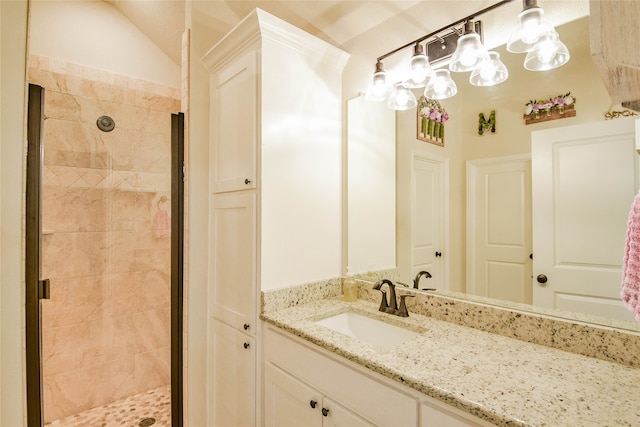 bathroom featuring vanity and a shower with door