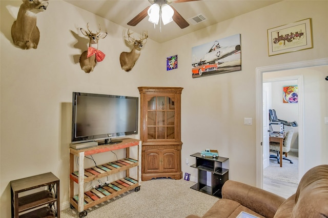 carpeted living room with ceiling fan