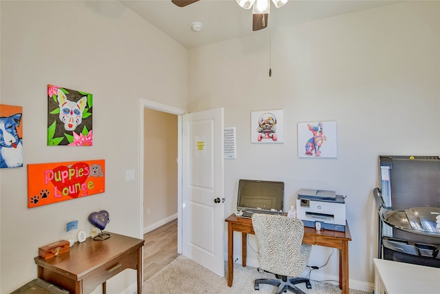 office with light wood-type flooring, ceiling fan, and high vaulted ceiling