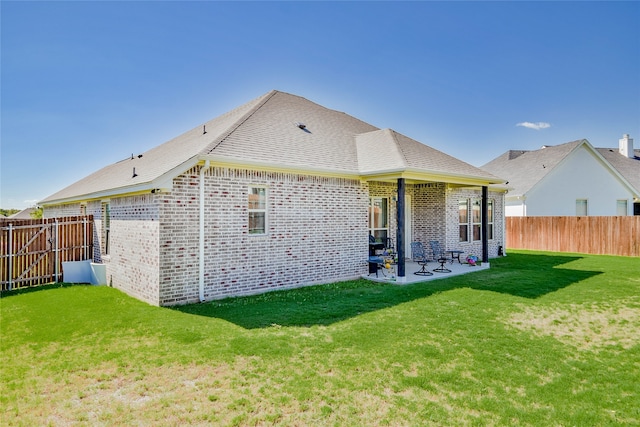 back of house with a yard and a patio area