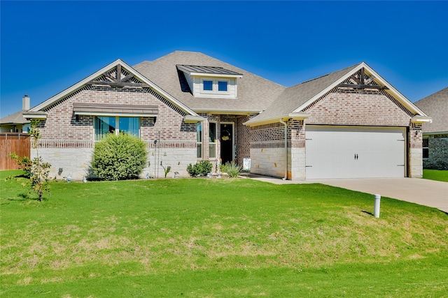 view of front of home with a garage and a front lawn