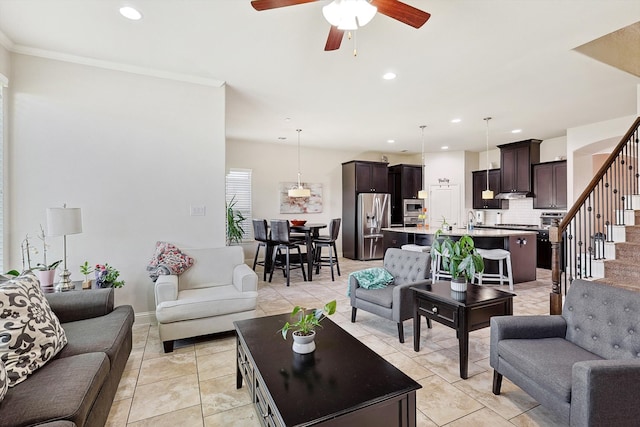 living room featuring crown molding, light tile patterned floors, and ceiling fan