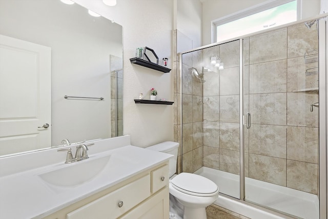 bathroom with toilet, walk in shower, and vanity