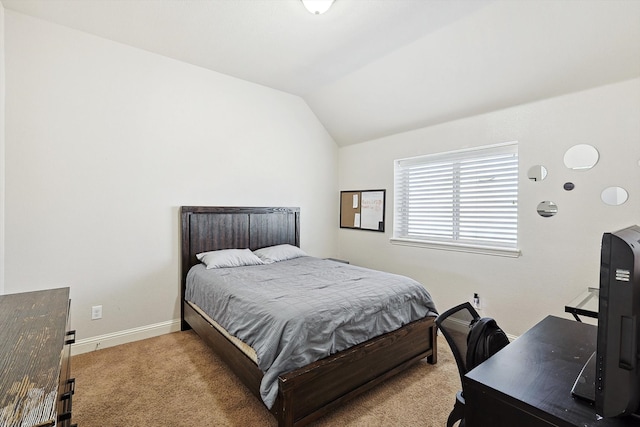 carpeted bedroom featuring lofted ceiling