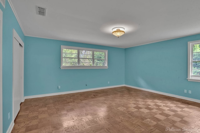 spare room with parquet flooring and ornamental molding