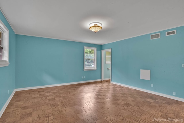 spare room with parquet flooring and ornamental molding