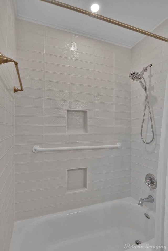 bathroom with ornamental molding and shower / bathtub combination with curtain