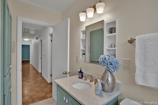 bathroom featuring vanity, crown molding, toilet, and parquet floors