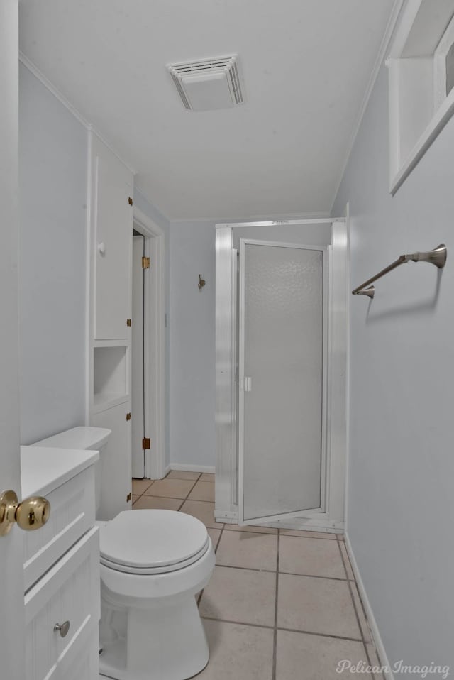 bathroom featuring a shower with shower door, toilet, vanity, ornamental molding, and tile patterned flooring