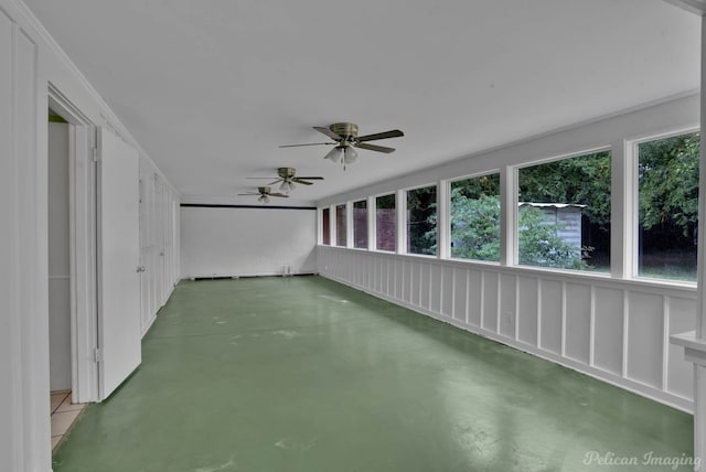 unfurnished sunroom with ceiling fan