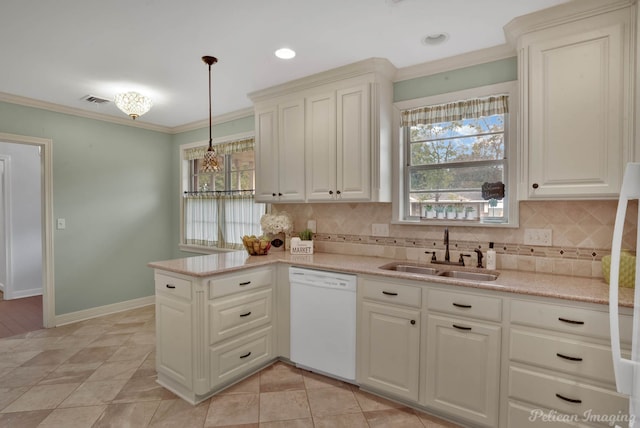 kitchen featuring sink, dishwasher, a wealth of natural light, and hanging light fixtures