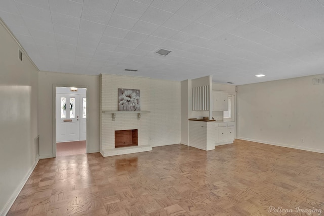 unfurnished living room with light parquet floors and a fireplace