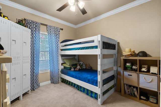 carpeted bedroom with ceiling fan and crown molding