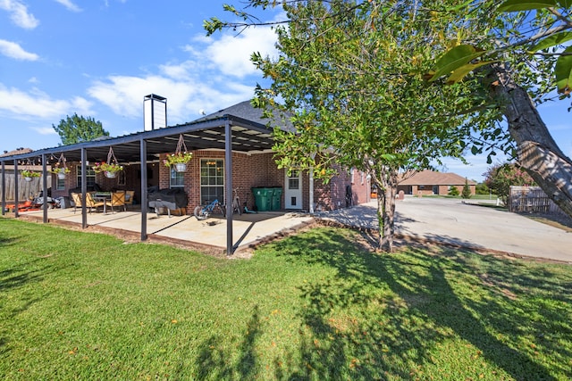 exterior space featuring a front yard and a patio area