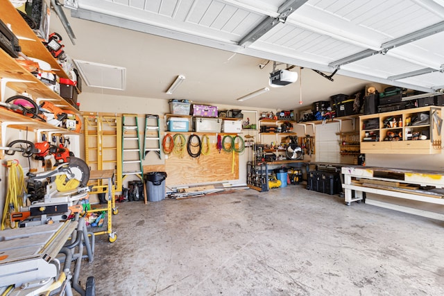 garage with a garage door opener and a workshop area