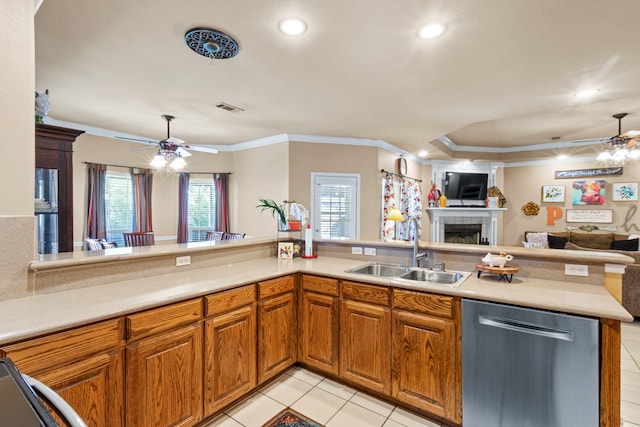 kitchen with sink, kitchen peninsula, a fireplace, ceiling fan, and stainless steel dishwasher