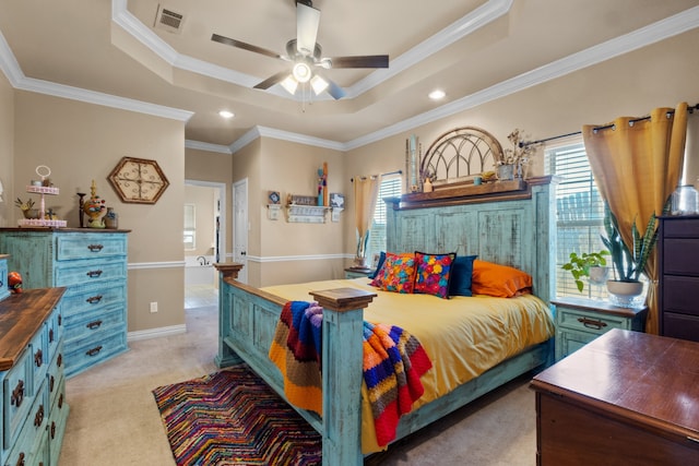 bedroom with a tray ceiling, ornamental molding, light carpet, and ceiling fan