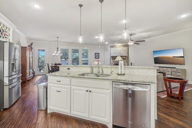 kitchen with sink, white cabinetry, stainless steel appliances, and dark wood-type flooring