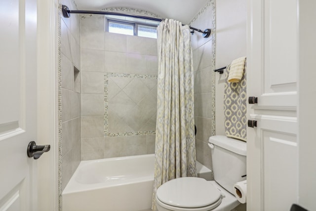 bathroom featuring shower / bath combination with curtain and toilet