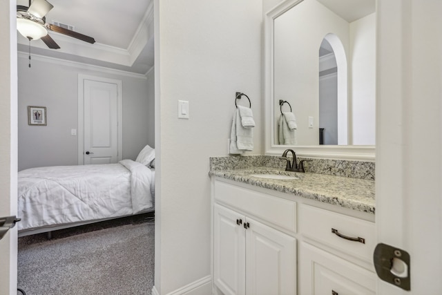 bathroom featuring ceiling fan, crown molding, and vanity