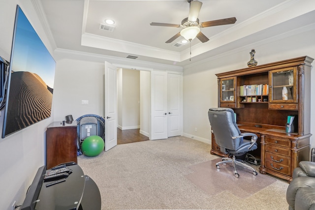 office area with a raised ceiling, crown molding, ceiling fan, and carpet